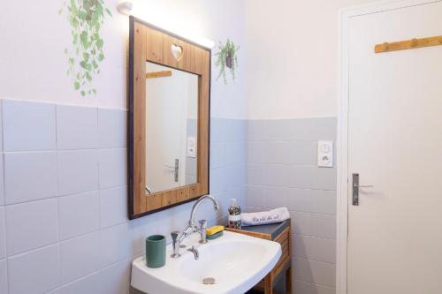 a bathroom with a sink and a mirror at Jolie maison cosy in Saint-Uze