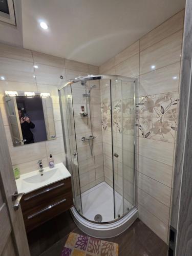 a bathroom with a shower and a sink at Lux House in Peterborough
