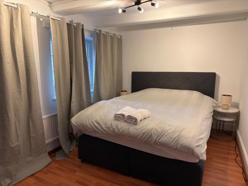a bedroom with a bed with two towels on it at Rooms4Rent in Bottmingen
