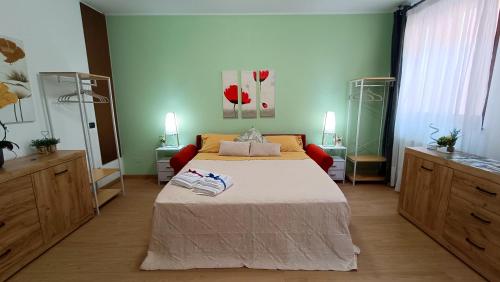 a bedroom with a bed and two dressers at Sweet Simo House in Azzate