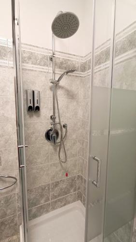a shower with a glass door in a bathroom at Sweet Simo House in Azzate