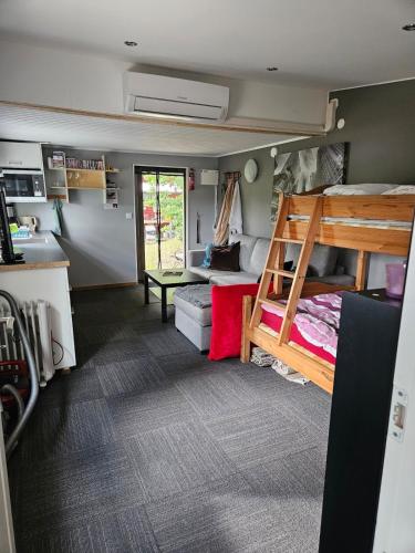 a room with a bunk bed and a couch at Klevenius in Gnesta