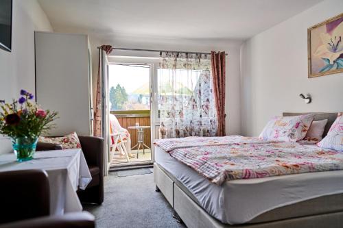 a small bedroom with a bed and a balcony at Gasthof ALTE POST-Schwarzwald Plus gratis in Waldachtal