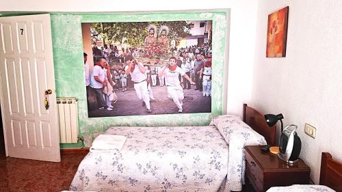 a bedroom with a poster on the wall with a bed at Pensión Isasa in Arnedo