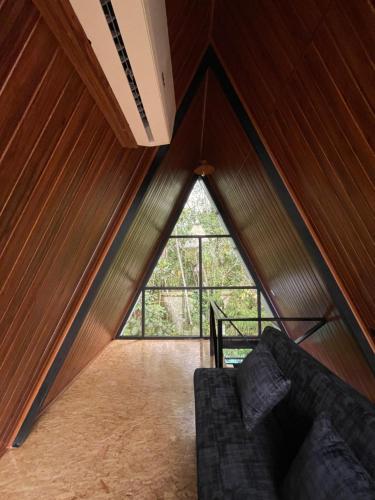 a room with a large window in a house at Refugio de la niebla puyo glamping in Puyo