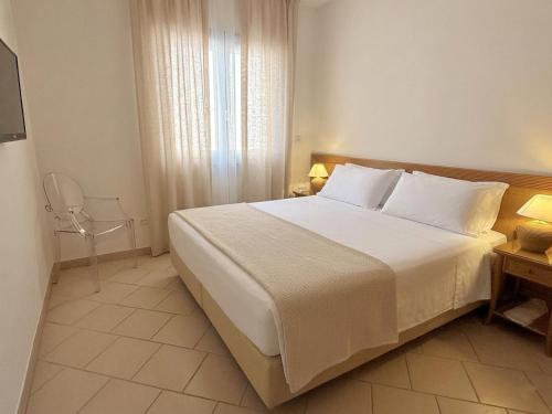 a bedroom with a large bed and a window at Residence Alle Palme in Riva del Garda
