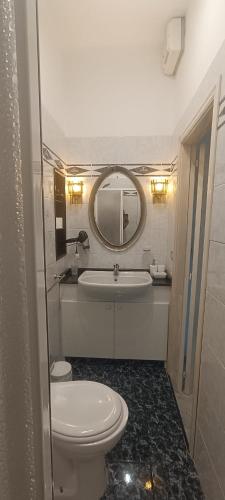 a bathroom with a toilet and a sink and a mirror at Penthouse in the historical center with sea view 5 minutes away,400mt, from main square in Amalfi