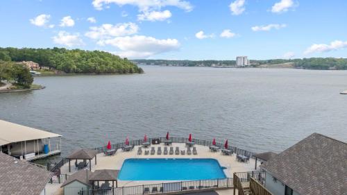 a view of a large body of water with a pool at Daylight Cove Lakefront Chic in Lake Ozark