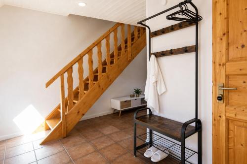 a staircase in a house with a chair in a hallway at Ferienwohnungen auf Reiterhof in Kevelaer in Kevelaer