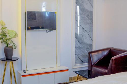 a living room with a chair and a window at Henry George Hotel Ltd in Idimu