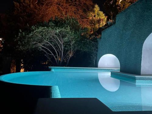 a swimming pool in a yard at night at Terrazza Tragara in Capri
