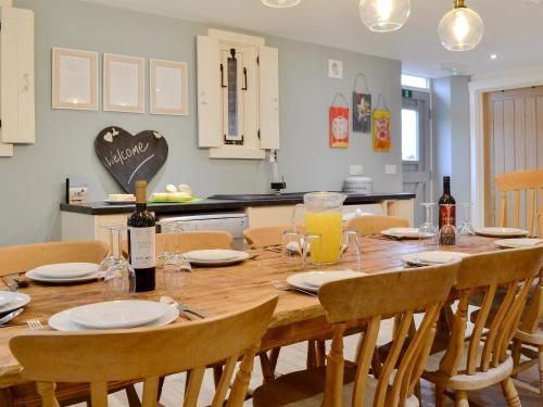 a wooden table with chairs and a dining room at Ey Up - Uk11447 in Skipsea