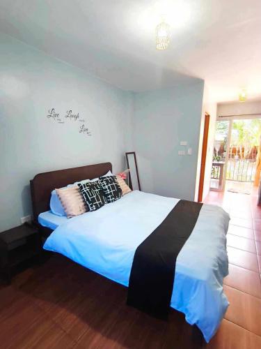 a bedroom with a bed in a room at Marias's Inn in Pooc