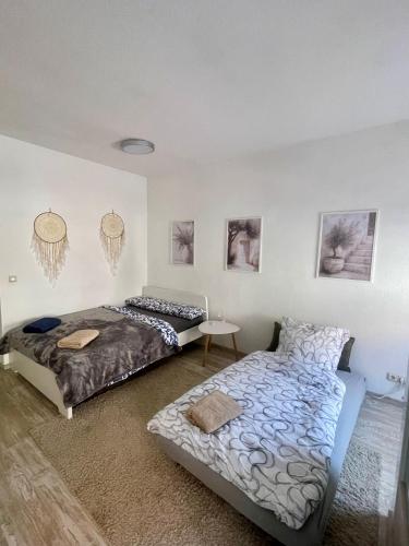 a bedroom with two beds and a table in it at Bike & Relax in Bernburg
