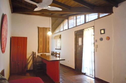 a living room with a ceiling fan and a counter at Cabañas Alfar Sol y Mar in Mar del Plata