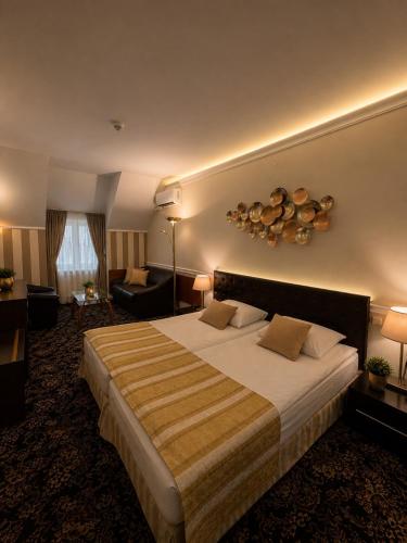a hotel room with a large bed and a living room at Hotel Cheap - Smart choice - Great value in Sofia