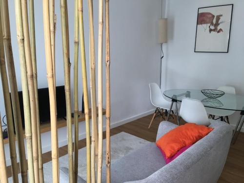 a living room with a couch and a glass table at Casa Pedra do Sal in Estoril