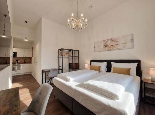a bedroom with a large bed and a chandelier at Pension Mozart - Vienna Center, Self Check-in in Vienna