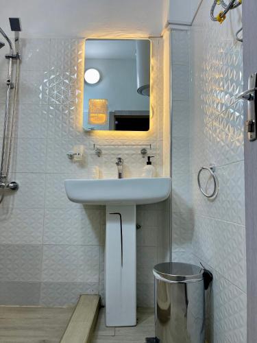 a bathroom with a sink and a mirror at Welcome Home 102 SaintLouis in Saint-Louis