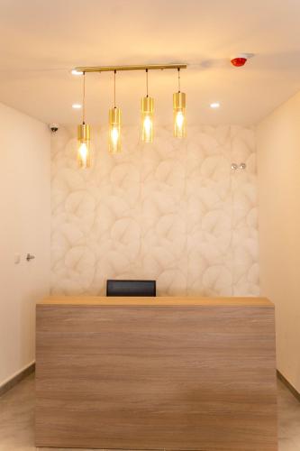 a lobby with a reception desk with three chandeliers at lovely cityscape in Lagos
