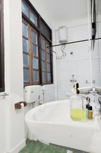 a white bath tub in a bathroom with a window at Kalimpong Bungalow in Kalimpong