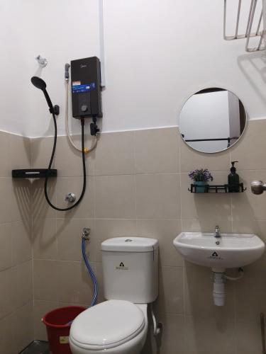 a bathroom with a toilet and a sink at Yashz Guest House in Port Dickson