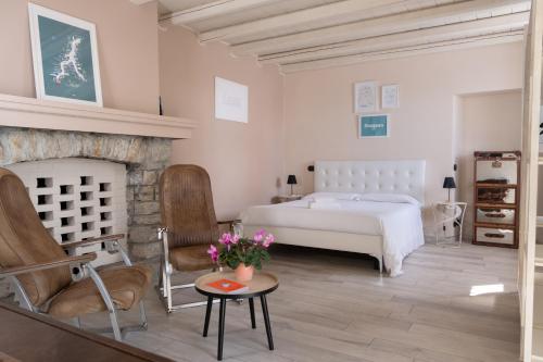 a bedroom with a bed and a fireplace at Casale Raffaello B&B Como in Albese Con Cassano