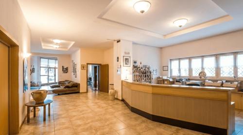 a large room with a counter and a lobby at Hotel Paolino in Cavareno