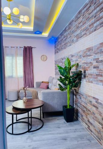 a living room with a couch and a table at Welcome Home 102 SaintLouis in Saint-Louis