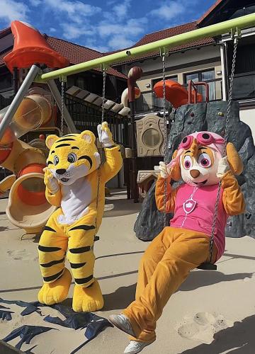 two stuffed animals sitting on a swing at Arena Slonca in Łeba