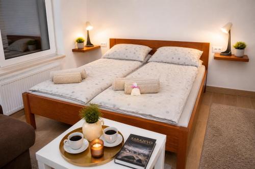 a bedroom with a bed and a coffee table at Charm Apartment-Cathedral area-Self Check-in in Sarajevo