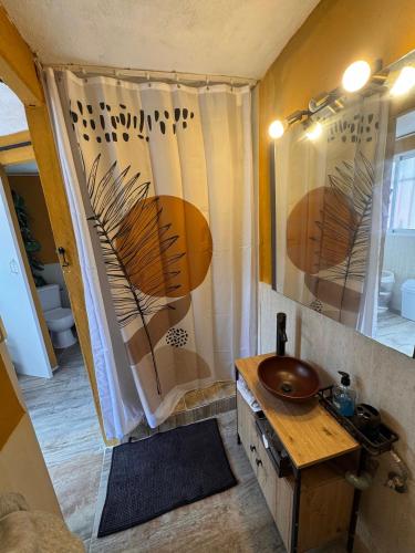 a bathroom with a sink and a shower at Finca El Escondite in Olocau