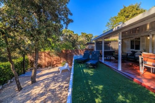 a backyard with a pool and a house at ESTRADA MOBILE HoME in Biograd na Moru