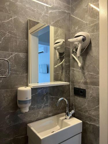 a bathroom with a sink and a mirror at Lilia Homes in Fethiye