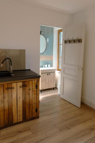 a kitchen with a sink and a counter top at La batisse du Champ Manneret Maison d'hôte Falaise - logement entier in Falaise