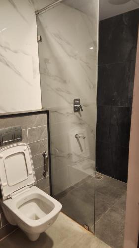 a bathroom with a toilet and a shower at Holiday Home Madurai - Duplex Villa Umachikulam in Madurai
