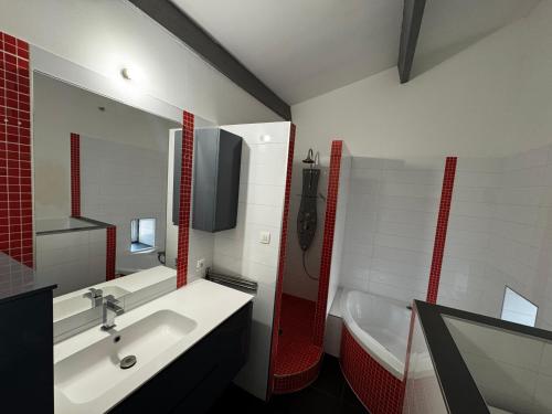 a bathroom with a white sink and a tub and a sink at Maison de Village 4 chambres in Sabran