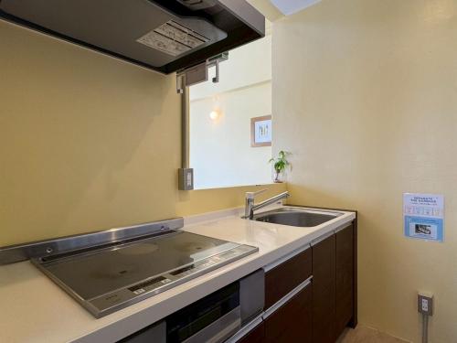 a small kitchen with a sink and a mirror at Anniversario in Onna