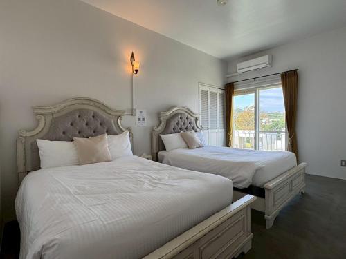 a bedroom with two beds and a window at Anniversario in Onna