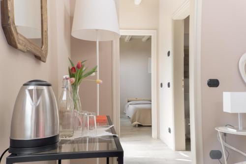 a kitchen with a table with a coffee maker and a mirror at Casale Raffaello B&B Como in Albese Con Cassano