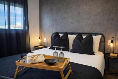 a bedroom with a large bed with a wooden table at The Lithos Loft Kyma in Ayía Marína