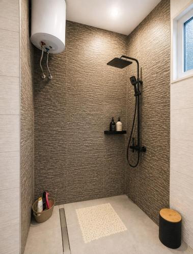 a bathroom with a shower with a shower head at Sea View Borsh Albania in Borsh