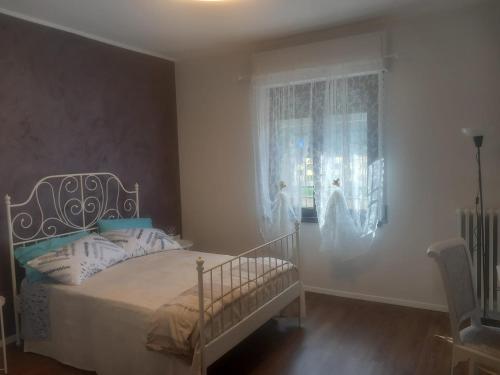 a bedroom with a bed and a window at Baby Home in Dalmine