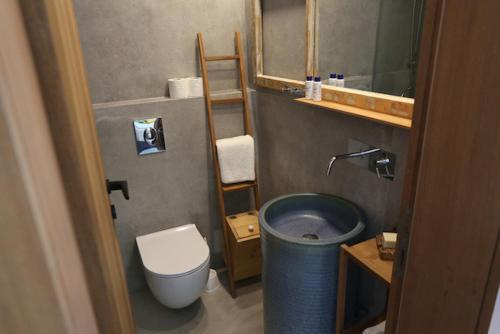 a small bathroom with a toilet and a sink at Villa Paradiso Batroun in Batroûn