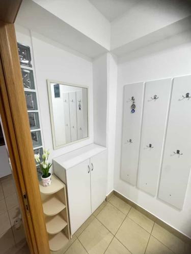 a bathroom with white cabinets and a mirror at Ohrid Demarko Apartment in Ohrid