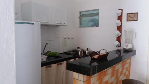 a kitchen with a sink and a counter top at Flat Matriz in Viçosa do Ceará