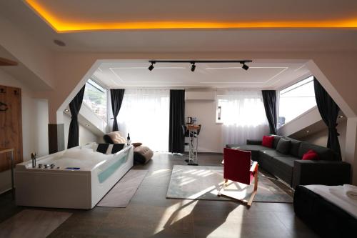 a living room with a bed and a couch at Hotel Besfort in Prizren