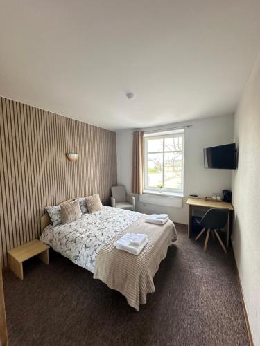 a hotel room with a bed and a desk at Vievija Hotel in Vievis