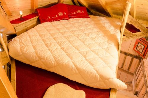 a bed in a wooden room with at Dolomiti Village in Comeglians