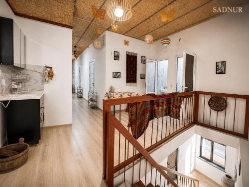 a living room with a staircase in a house at Family Guest House SadNur in Bukhara